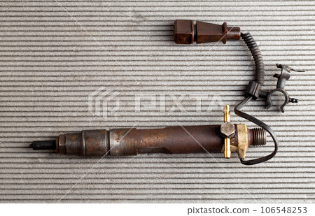 Electric control nozzle from a diesel engine, close-up. Copy space for text Electric control nozzle from a diesel engine, close-up. Copy space for text 106548253