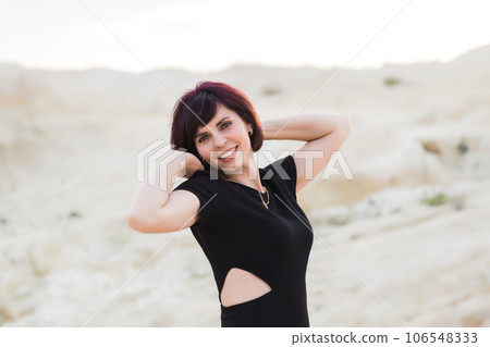 Beautiful sexy woman laughing posing in the desert, photo session in Dubai Beautiful sexy woman laughing posing in the desert, photo session in Dubai 106548333