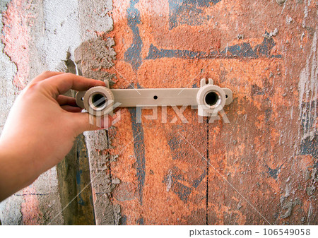 fittings in plumbing for hot and cold water in the wall, close-up 106549058