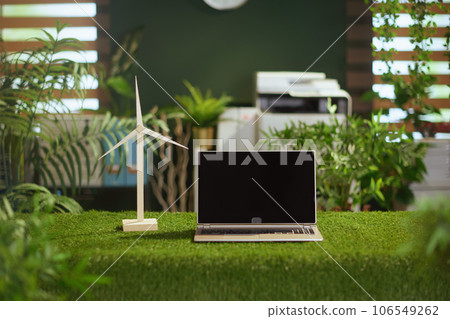 grass table in modern green office with laptop and blank screen 106549262