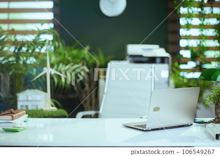 desk in modern green office with laptop desk in modern green office with laptop 106549267