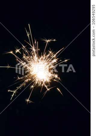 Bright sparkler light in the dark closeup Bright sparkler light in the dark closeup 106549295