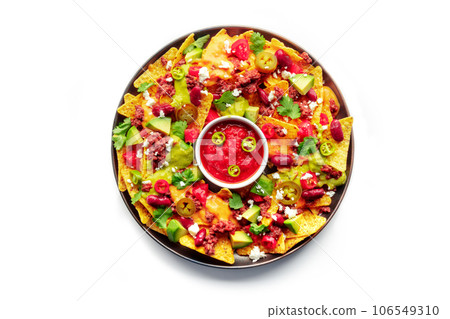 Loaded nachos. Mexican nacho chips with beef, overhead flat lay shot 106549310