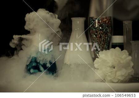 In a chemical laboratory, flasks filled with solutions in smoke. 106549653