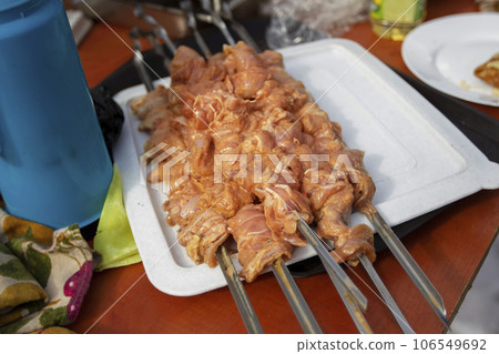 Chicken skewers marinated on skewers and ready to cook. Semi-finished product for barbecue. Chicken skewers marinated on skewers and ready to cook. Semi-finished product for barbecue. 106549692