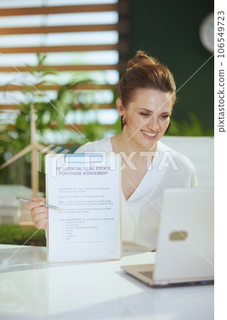 smiling business woman in green office having video conference smiling business woman in green office having video conference 106549723