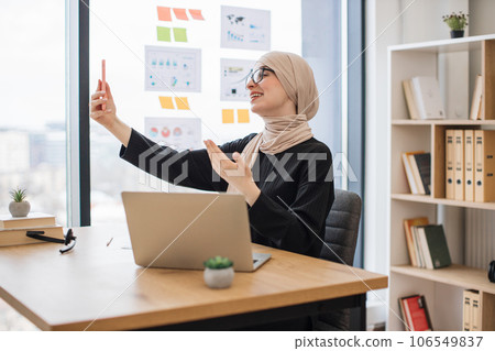 Assistant joining online meeting via phone at office desk 106549837