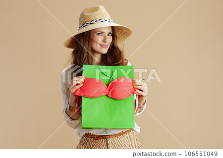 smiling trendy housewife in blouse and shorts isolated on beige 106551049