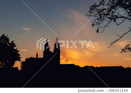 Scenic view of old ancient Magdeburger Dom cathedral at Dom square in Magdeburg old city center against bright warm dramatic sunset sky. Germany tourism and travel destiantion 106551334