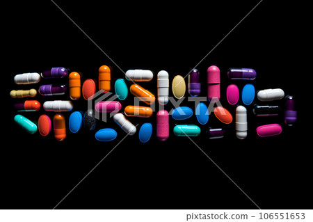 Pharmaceutical medicine pills, tablets and capsules on black background. Copy space for text 106551653