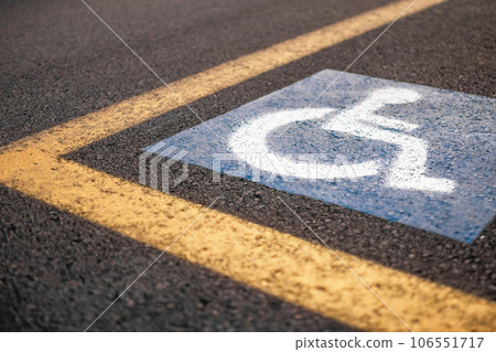 Parking sign for disabled on asphalt with yellow lines Parking sign for disabled on asphalt with yellow lines 106551717