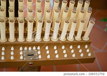 Candles of supplication and wishes on altar of Church with slot to insert coin Candles of supplication and wishes on altar of Church with slot to insert coin 106551750
