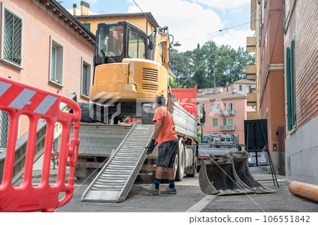 Construction Area with Operators deploying barrier, excavator and working ground Construction Area with Operators deploying barrier, excavator and working ground 106551842