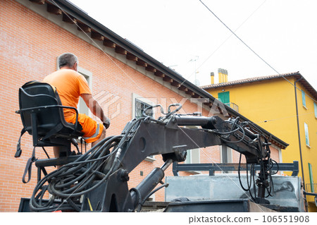 Operator controlling excavator while asphalting in Construction Area Operator controlling excavator while asphalting in Construction Area 106551908