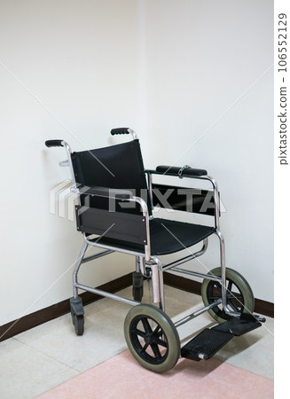 Black Wheelchair on hospital floor with white background Black Wheelchair on hospital floor with white background 106552129