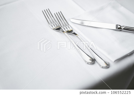 Close up view of cutlery, tablecloth and napkin from Elegant Restaurant table 106552225
