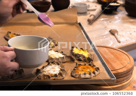 Prepairing Karelian pasties with mashed potato and carrot filling 106552368