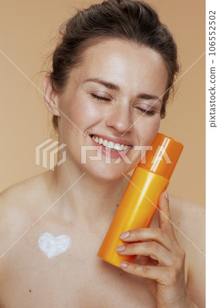 happy modern 40 years old woman with cosmetic cream jar 106552502