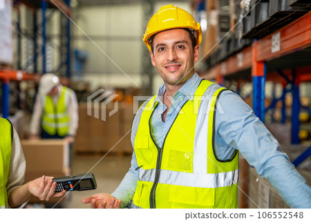 Warehouse workers talking together checking goods in storage Warehouse workers talking together checking goods in storage 106552548