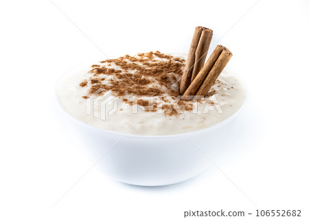 Arroz con leche. Rice pudding with cinnamon in white bowl isoalted on white background 106552682