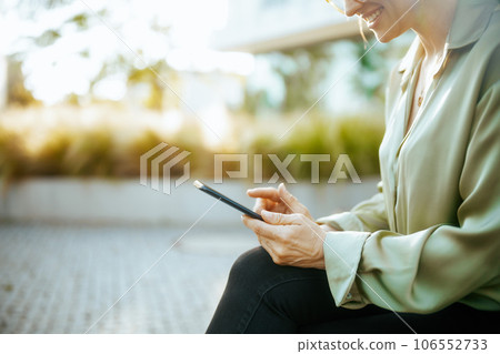 Happy female employee in green blouse and eyeglasses Happy female employee in green blouse and eyeglasses 106552733