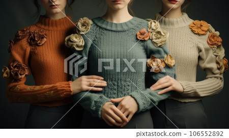 Three girls in autumn sweaters with flowers.The concept is modern, eco-friendly and unusual fashion. 106552892