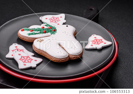 A beautiful Christmas composition consisting of ceramic plates, gingerbread and other elements A beautiful Christmas composition consisting of ceramic plates, gingerbread and other elements 106553313