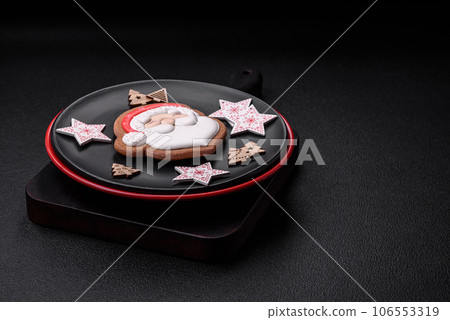 A beautiful Christmas composition consisting of ceramic plates, gingerbread and other elements 106553319