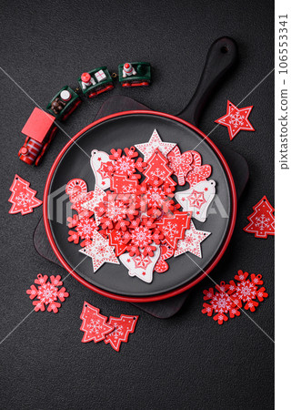 A beautiful Christmas composition consisting of ceramic plates, gingerbread and other elements A beautiful Christmas composition consisting of ceramic plates, gingerbread and other elements 106553341