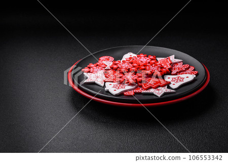 A beautiful Christmas composition consisting of ceramic plates, gingerbread and other elements A beautiful Christmas composition consisting of ceramic plates, gingerbread and other elements 106553342