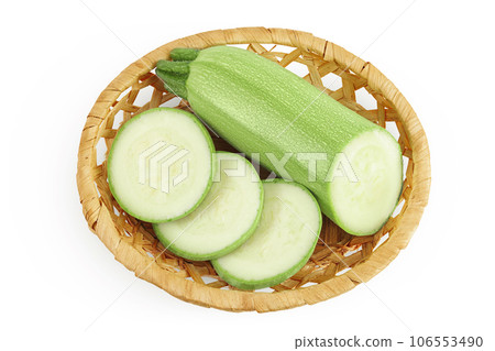 zucchini or marrow in a wicker basket isolated on white background with full depth of field. Top view. Flat lay 106553490