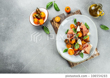 Salad with Prosciutto, ham jamon, tomatoes, cheese. Cold snacks. banner, menu, recipe place for text, top view 106554283