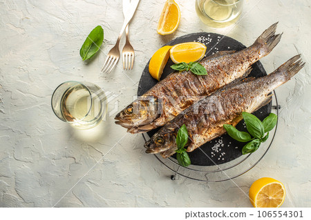 Baked sea Bass fish, grilled seabass with white wine. banner, menu, recipe place for text, top view Baked sea Bass fish, grilled seabass with white wine. banner, menu, recipe place for text, top view 106554301