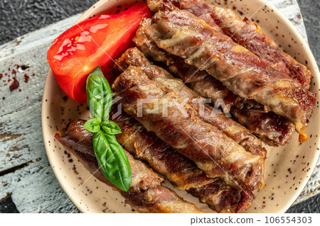 Stuffed Bacon Rolls. minced meat in bacon rolls. Food recipe background. Close up Stuffed Bacon Rolls. minced meat in bacon rolls. Food recipe background. Close up 106554303