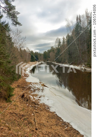 The banks of the river Salaca. Skanaiskalna nature park. Some ice on the shores in Latvia, Mazsalaca The banks of the river Salaca. Skanaiskalna nature park. Some ice on the shores in Latvia, Mazsalaca 106554806