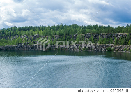 landscape with a clear lake on the site of an old stone quarry landscape with a clear lake on the site of an old stone quarry 106554846