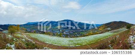 October Carpathian mountain with first winter snow on dirty road and village in valley. Ukraine. October Carpathian mountain with first winter snow on dirty road and village in valley. Ukraine. 106555386