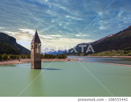 The bell tower in Reschensee and family (Italy). 106555442