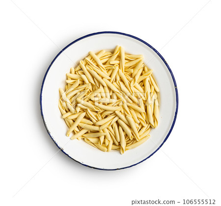 Fusilli pugliesi. Italian twisted pasta in plate isolated on white background. Fusilli pugliesi. Italian twisted pasta in plate isolated on white background. 106555512