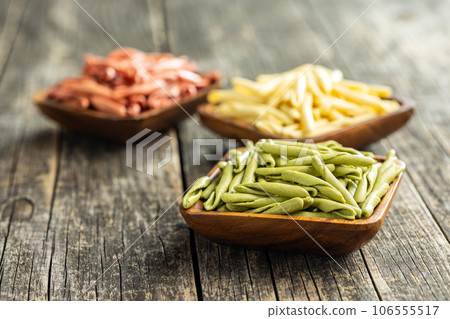 Fusilli pugliesi. Italian tricolor twisted pasta in bowl. 106555517