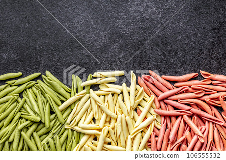 Fusilli pugliesi. Italian tricolor twisted pasta on black table. Top view. Fusilli pugliesi. Italian tricolor twisted pasta on black table. Top view. 106555532