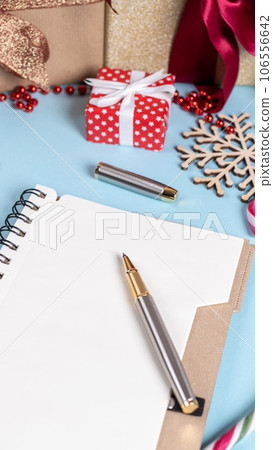 table with Christmas decoration and open wish list table with Christmas decoration and open wish list 106556642