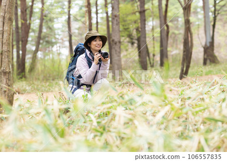A woman enjoying hiking and photography A woman enjoying hiking and photography 106557835