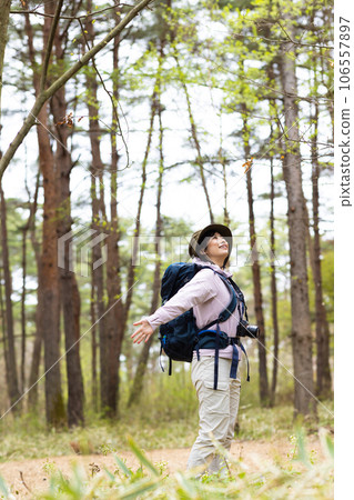 A woman enjoying hiking and photography A woman enjoying hiking and photography 106557897