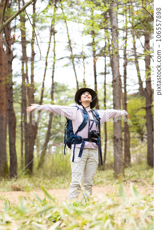 A woman enjoying hiking and photography A woman enjoying hiking and photography 106557898