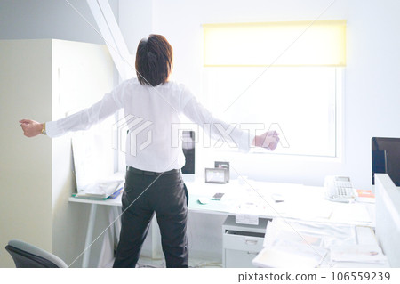 Business person stretching at desk Business person stretching at desk 106559239