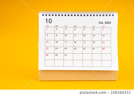 The October 2023, Monthly desk calendar for 2023 year on yellow color background. The October 2023, Monthly desk calendar for 2023 year on yellow color background. 106560331