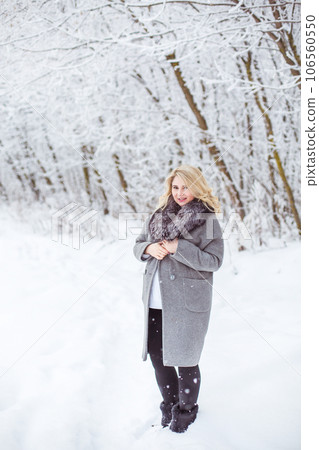 Portrait of beautiful happy woman in snowy winter forest Portrait of beautiful happy woman in snowy winter forest 106560550