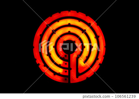 Coiled heating wire of a retro electric stove heated bright red (nichrome wire, black background photo) Coiled heating wire of a retro electric stove heated bright red (nichrome wire, black background photo) 106561239