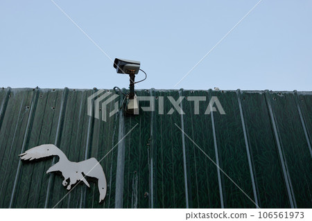 Surveillance camera installed on the fence at the construction site Surveillance camera installed on the fence at the construction site 106561973